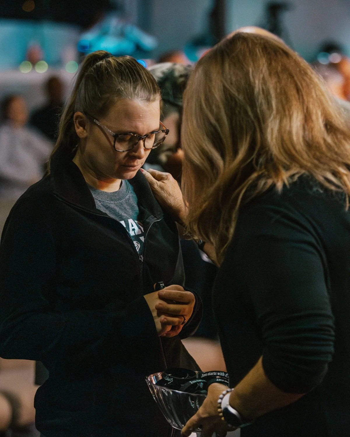 A New Life Church care team member praying with someone