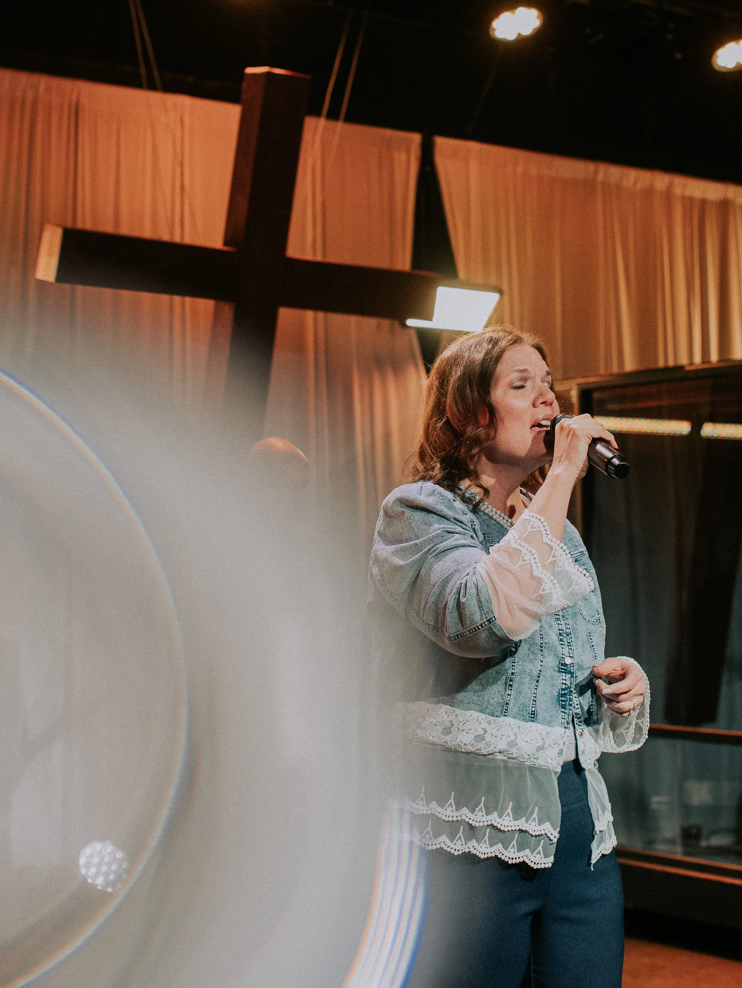 A vocalist leading worship at New Life Church