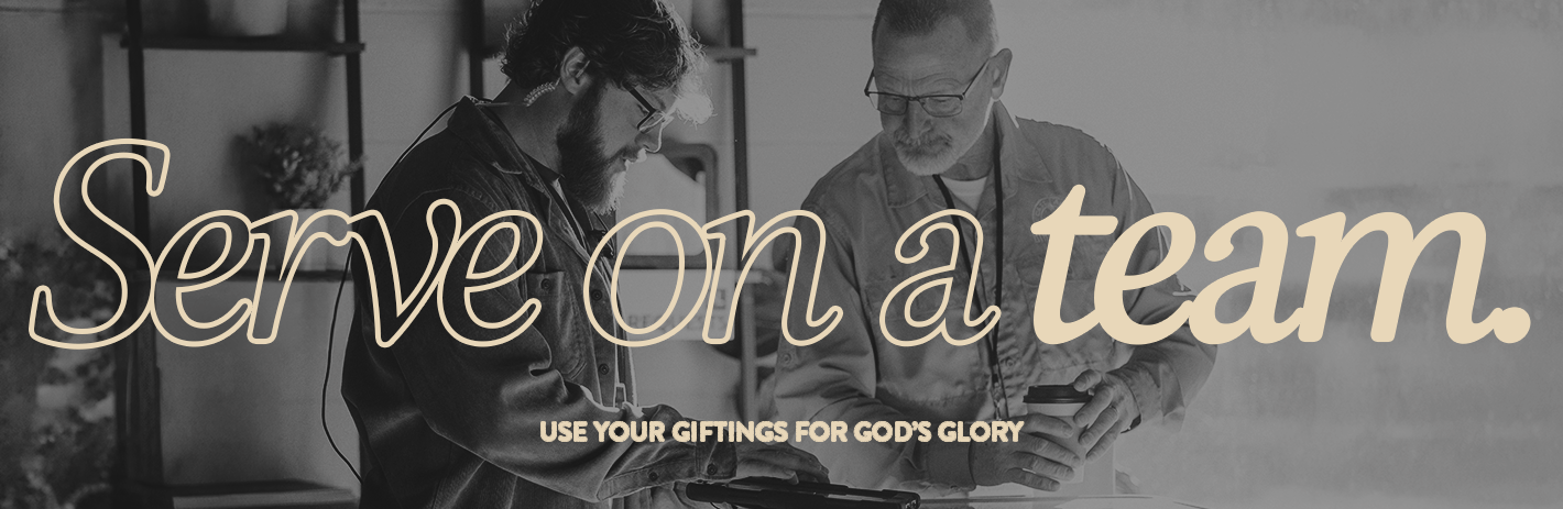 Two men working together in a modern indoor space, one wearing glasses and a denim jacket, the other with a beard and glasses, focusing on a device. Overlaid text reads 'Serve on a team. Use your giftings for God's glory.'