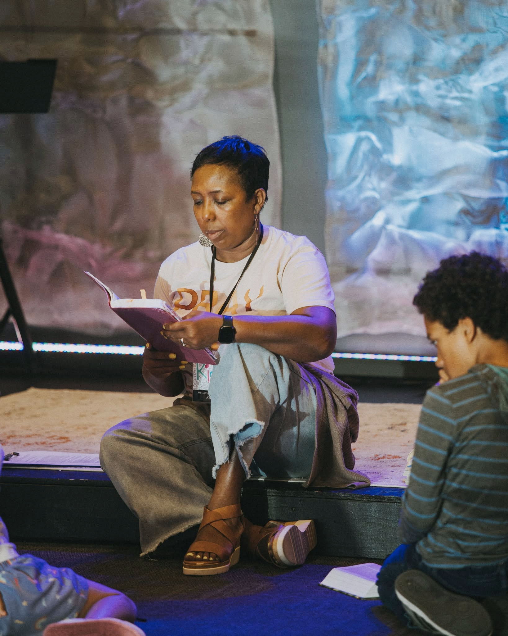 A New Life volunteer helping children read and learn
