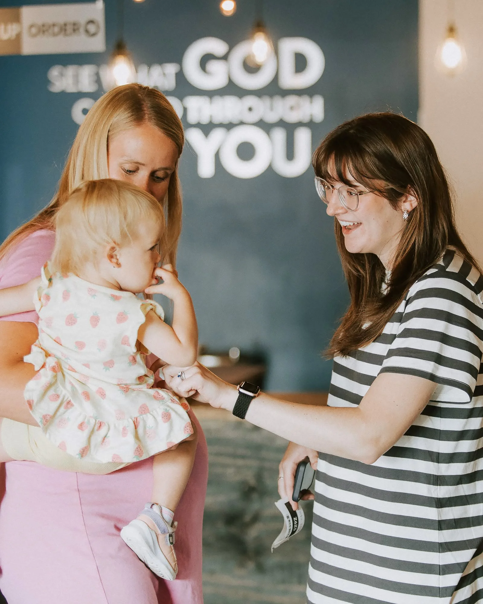 A New Life Church volunteer welcoming a parent and child