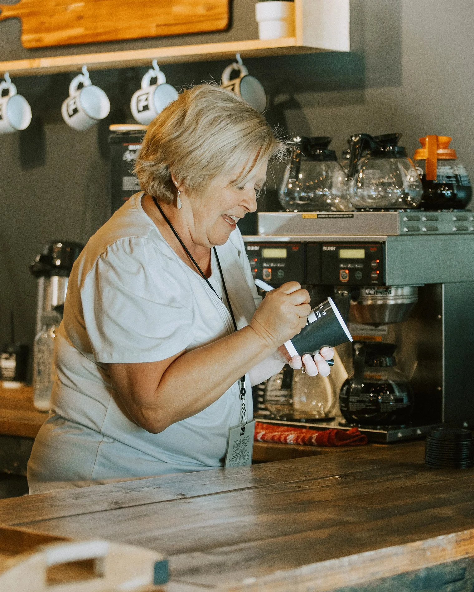A volunteer preparing coffee for guests at New Life Church