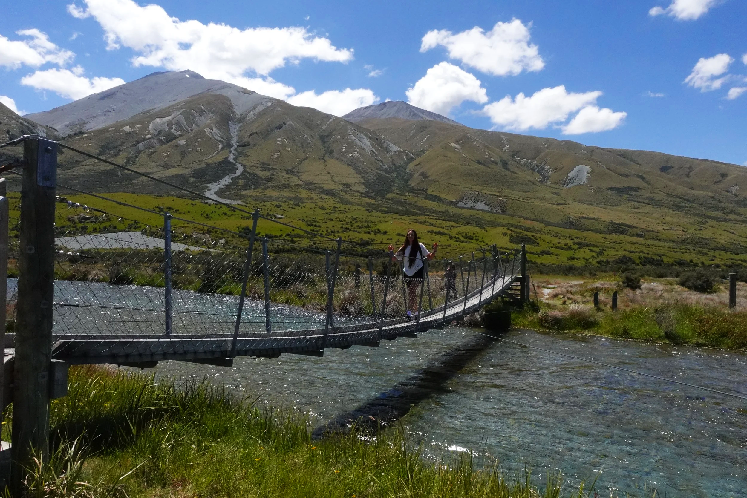 Crossing the swing bridge on the Mount Sunday Track