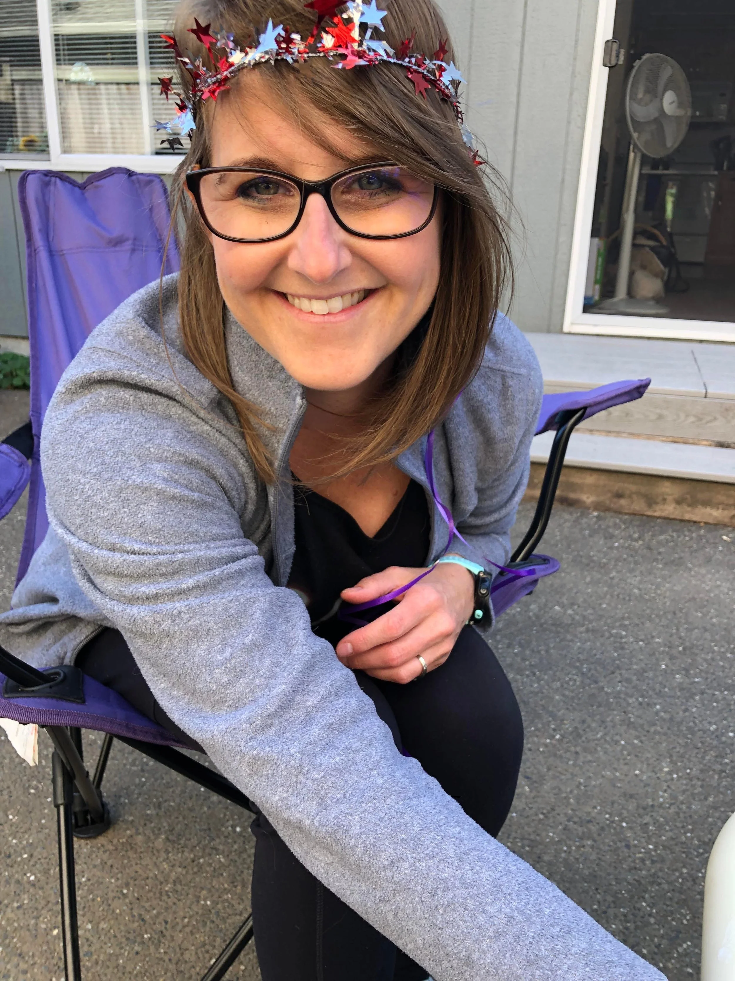 Picture of Christina Kressin BSN, RN, IBCLC sitting down in a chair with a star crown while smiling