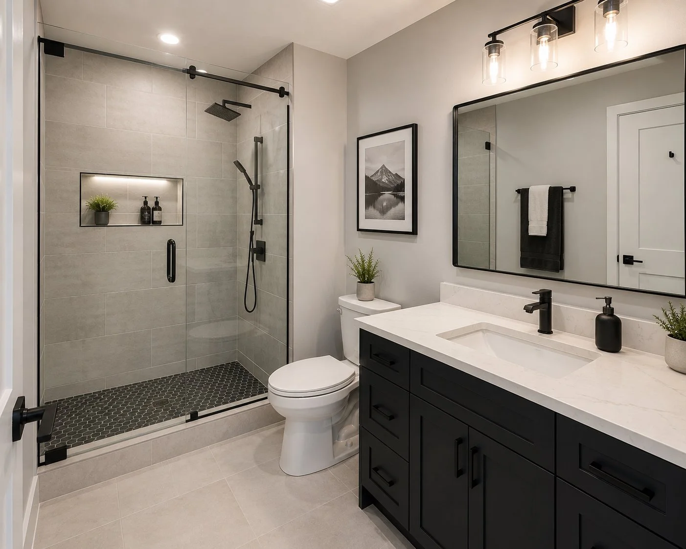 Modern bathroom with frameless glass shower, black fixtures, a black vanity with a white countertop, a large mirror, potted plants, and a framed black-and-white mountain photograph.