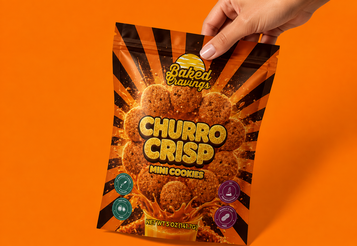 Hand holding a bag of Baked Cravings Churro Crisp Mini Cookies with a bright orange background. The package features an image of round, crispy mini cookies with a churro flavor, and the package design includes bold text and splashes of caramel-colored graphic.