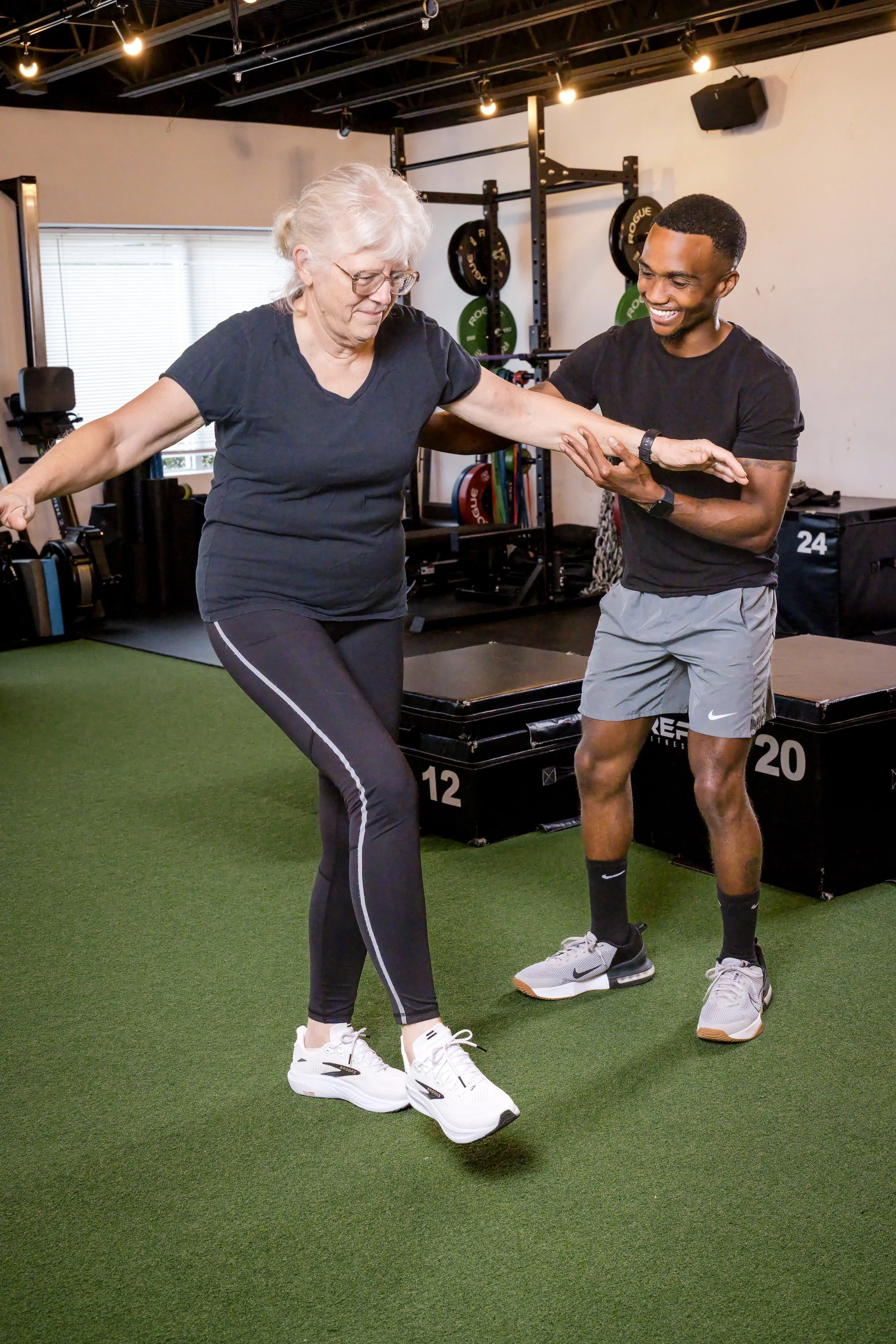 Chris Taylor assisting an older adult client with balance and mobility training.