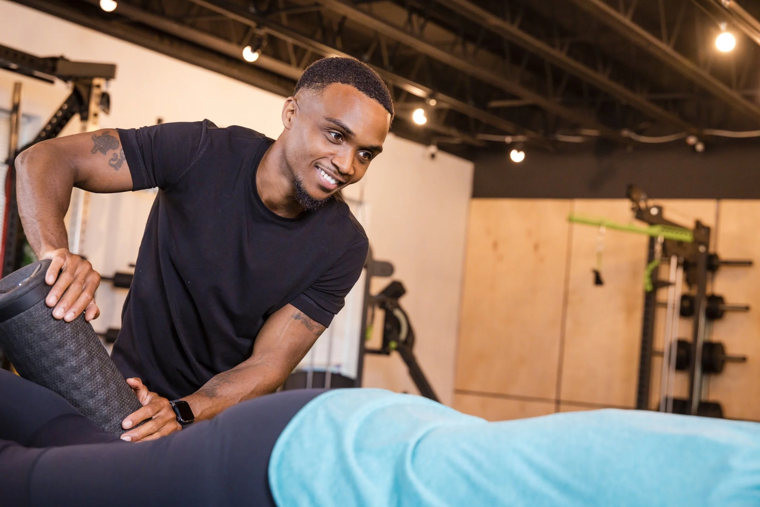 Chris Taylor providing assisted stretching to a client during a recovery session.