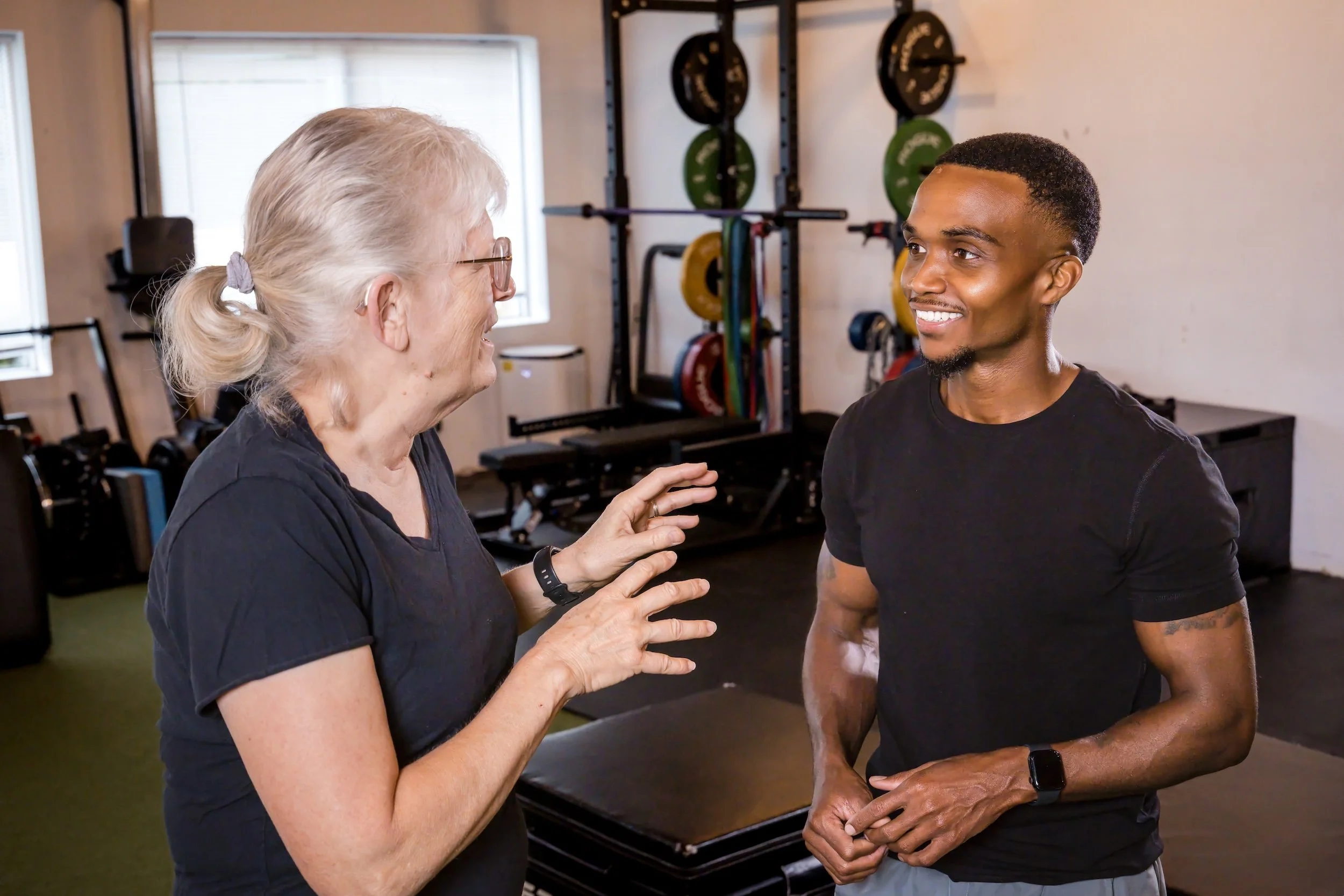 Chris Taylor speaking with an older adult client during a private consultation.