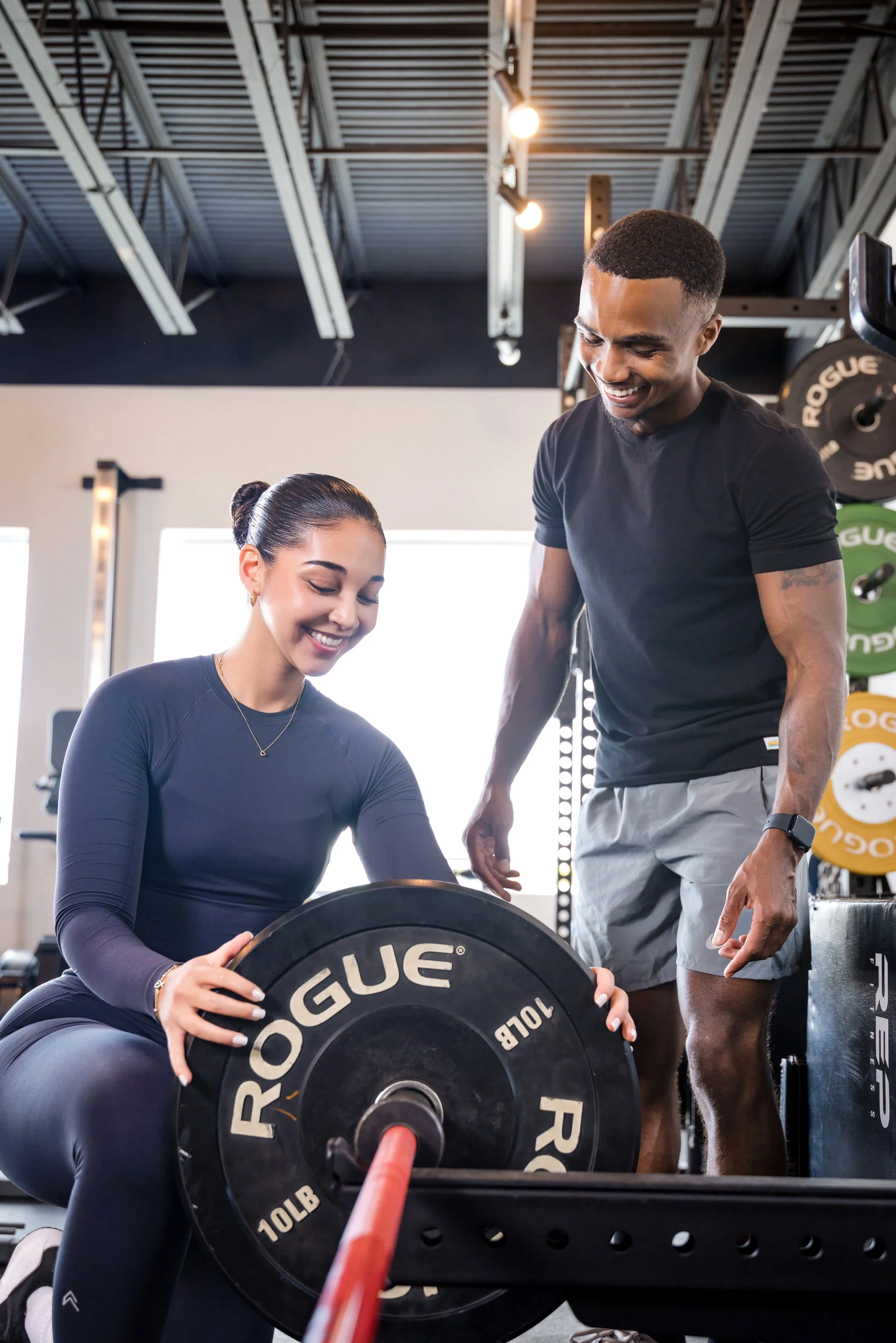 Chris Taylor coaching a client through a weighted strength exercise.
