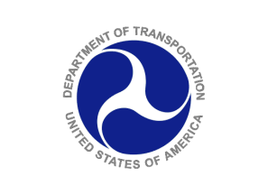 Logo of the U.S. Department of Transportation featuring a circular design with a white abstract shape inside a blue background, surrounded by the text 'Department of Transportation United States of America'.