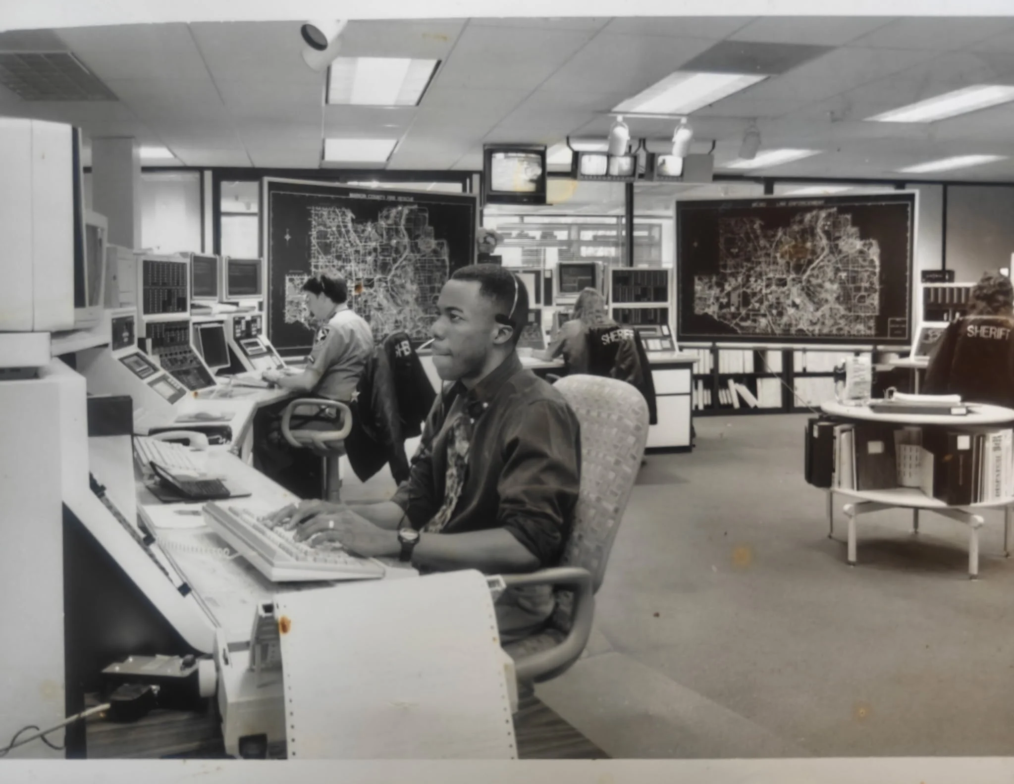 Christopher Bradford working in a Public Safety Communications facility as a telecommunicator.
