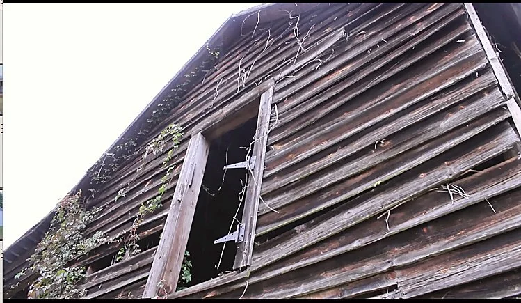 Weathered wooden barn siding and open window at Hendricks Family Farm.