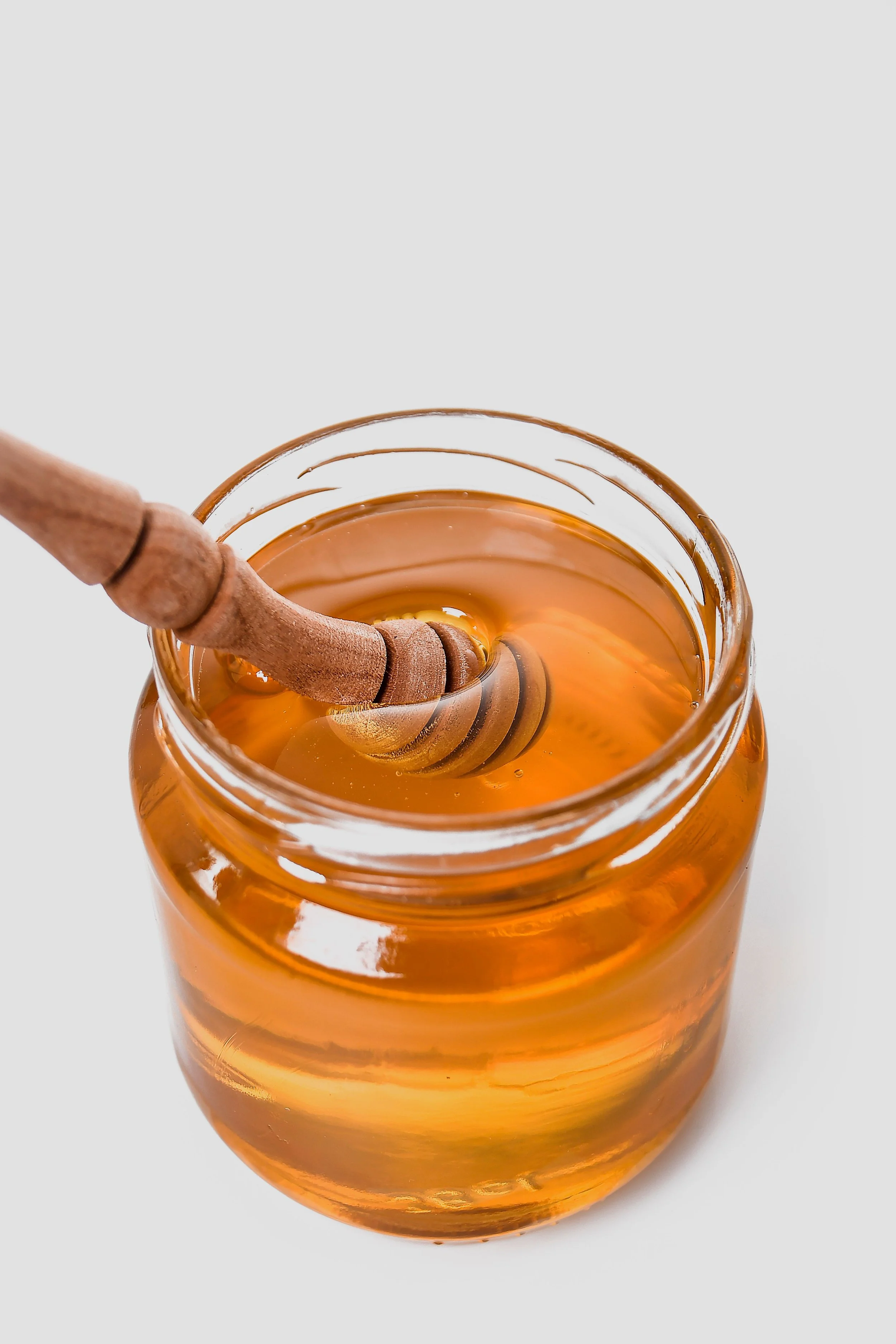 A jar of Block Island honey with a honey wand.