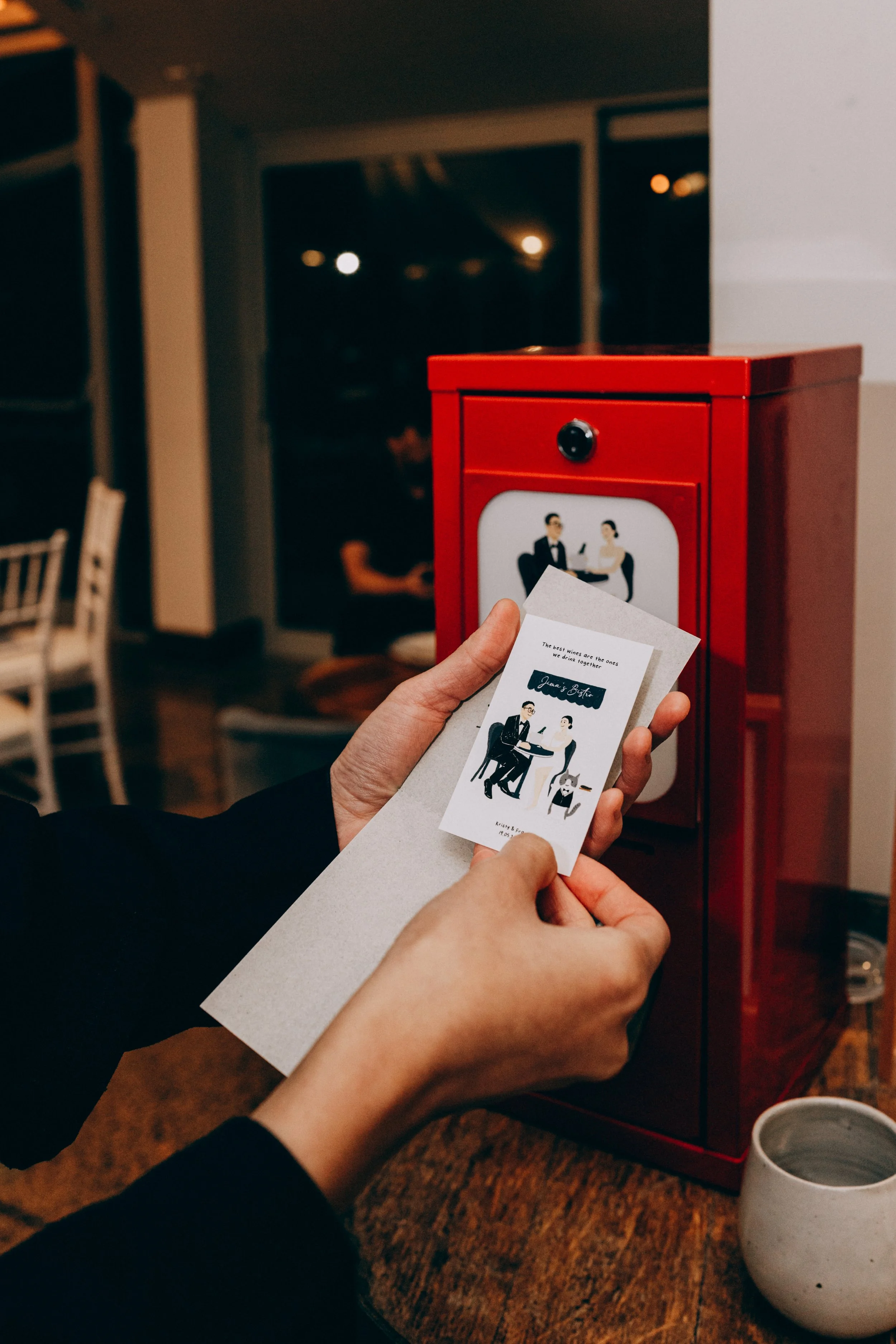 Couple at a wedding getting their mini prints from the mini print vending machine