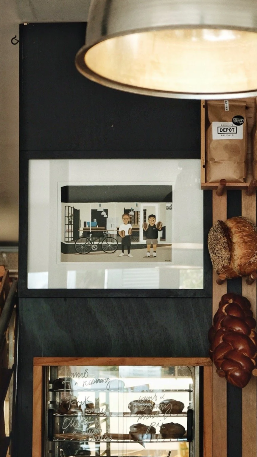 Custom cafe illustration with owners framed and displayed at the cafe