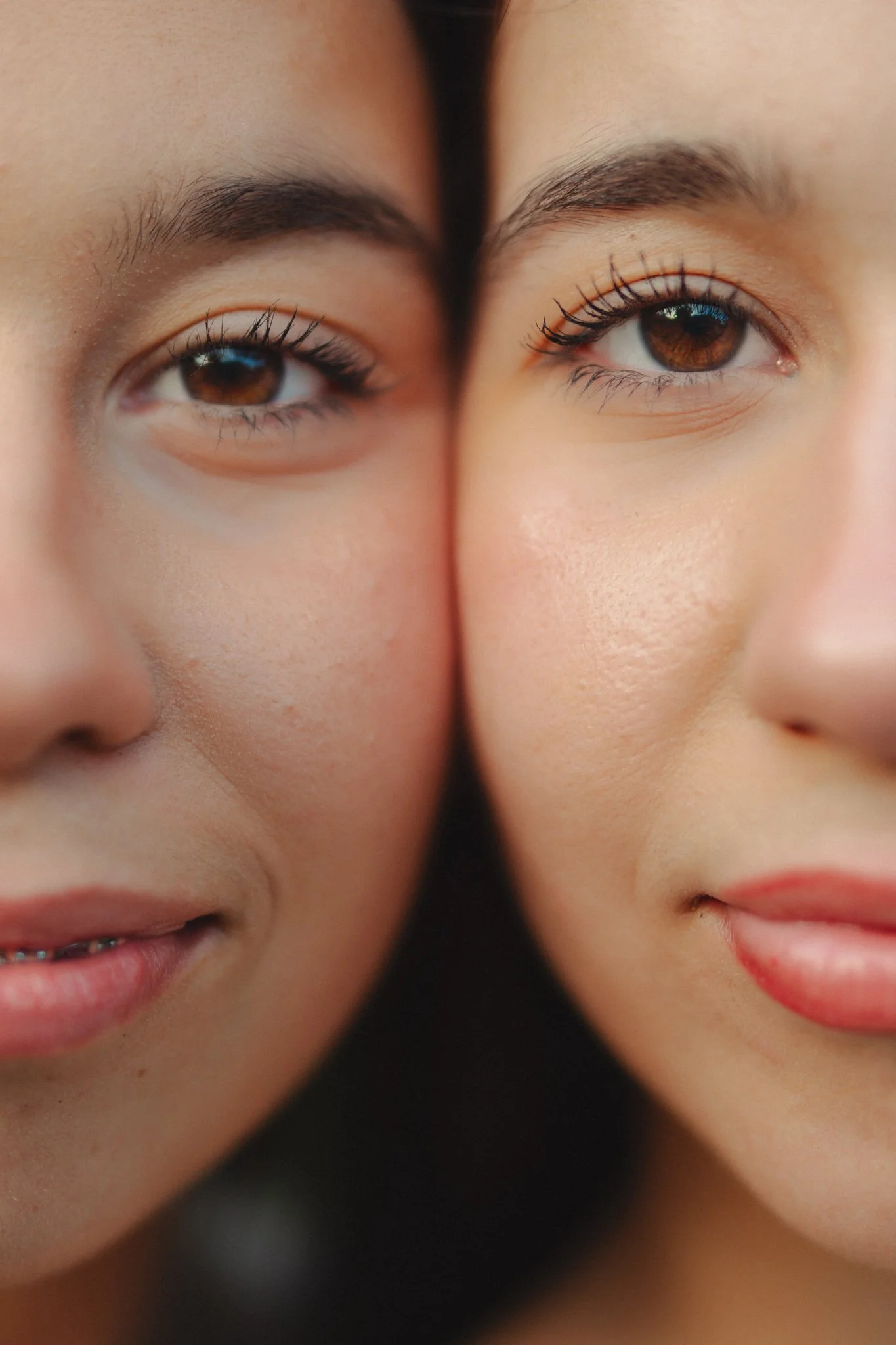 Close-up of two women's faces showing their eyes and part of their noses and mouths, with one woman on the left and one on the right.