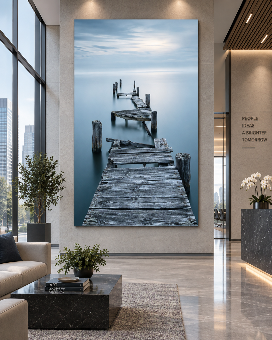 Large artwork of an old wooden dock extending into a calm body of water, with a cloudy sky above, displayed in a modern office lobby.