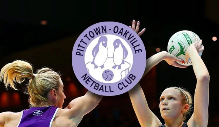 Two young female volleyball players, one with a ponytail and one with a bun, engaging in a volleyball game inside a gym. The girl on the right is holding a volleyball with both hands, and an emblem for Pittstown-Oakville Netball Club is centered in the image.