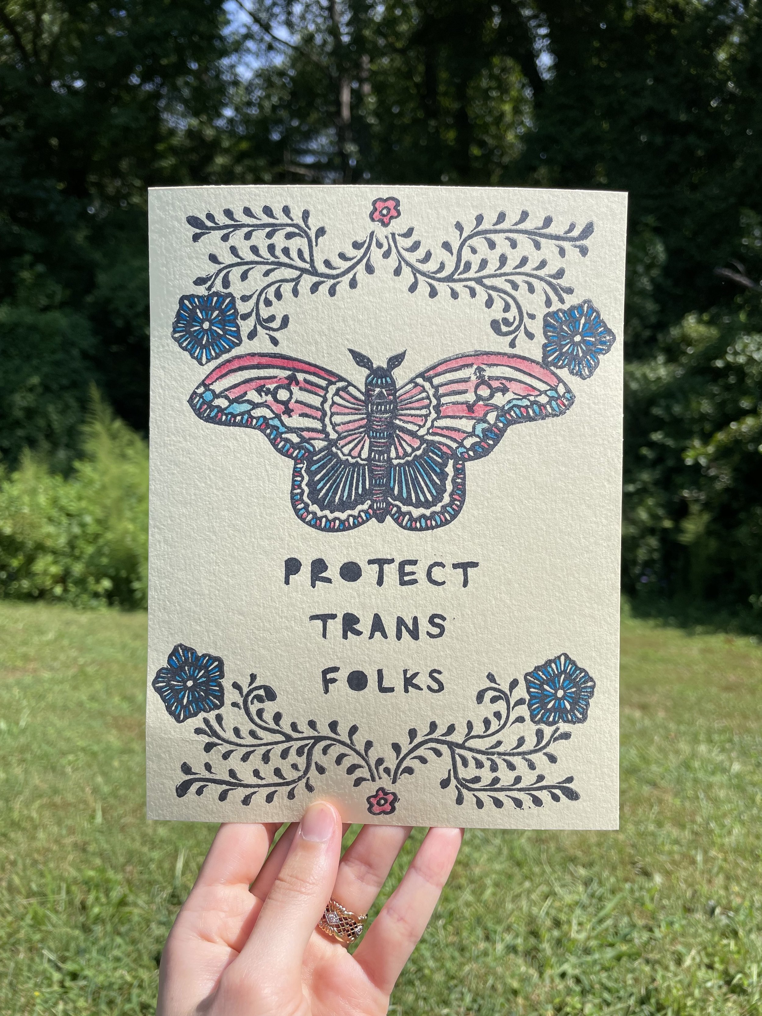 pink butterfly with blue flowers on cream paper.jpg