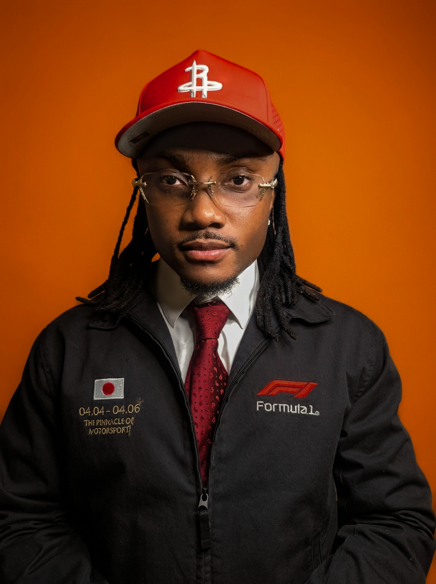 DJ Jino Spinz is shown in a Professional Portrait wearing a red cap, glasses, a black Formula 1 jacket with Japanese flag patch, white shirt, and red tie, set against an orange background.