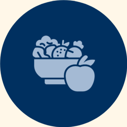 A bowl of assorted fruits with an apple in front.