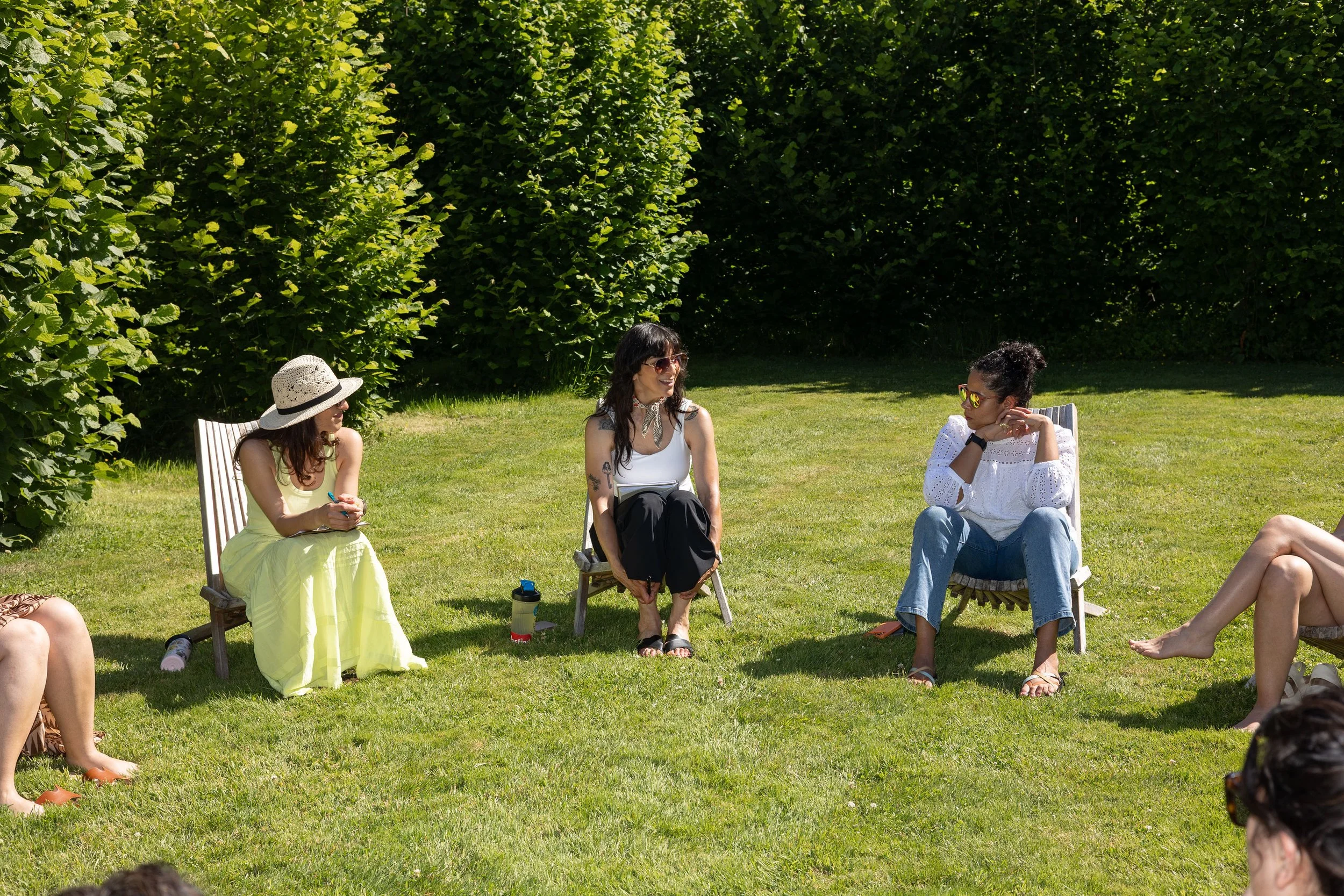 Clinicians seated together in an outdoor circle, building community and reflecting during a restorative farm CE retreat.