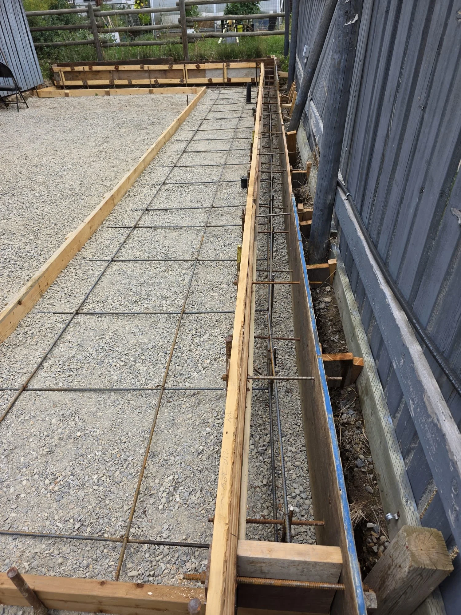 Construction site with wooden formwork and steel rebar, preparing for concrete pouring