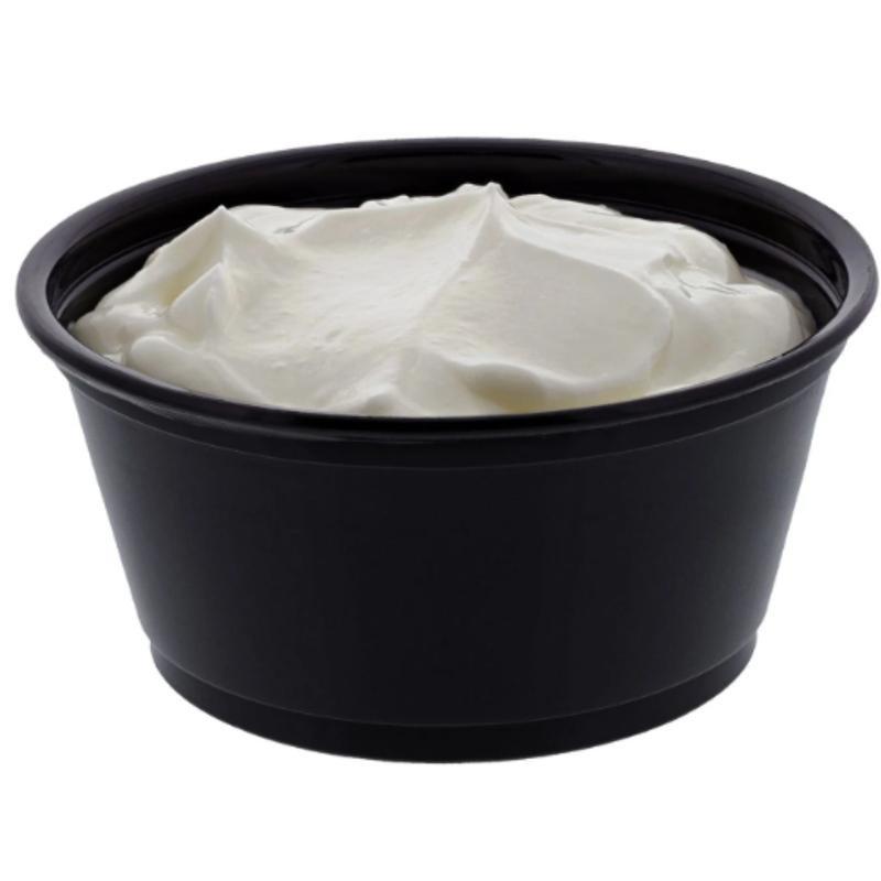 Black bowl filled with white sour cream.