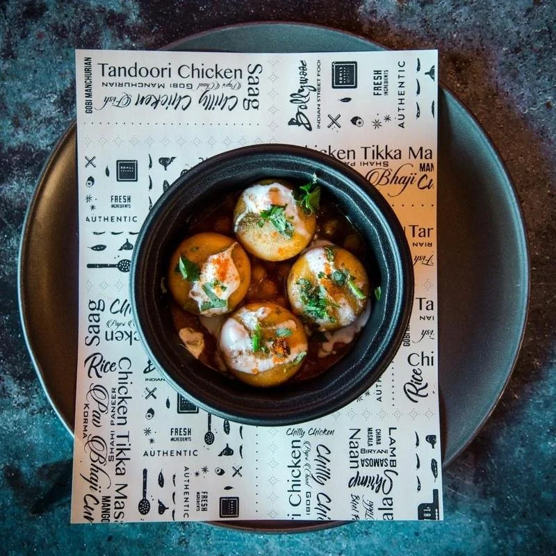 Crispy, deep-fried potato patty with mixtures of spices, splashed with mint and tamarind chutney and luscious yogurt sauce, with a layer of Chole. | Vegetarian
