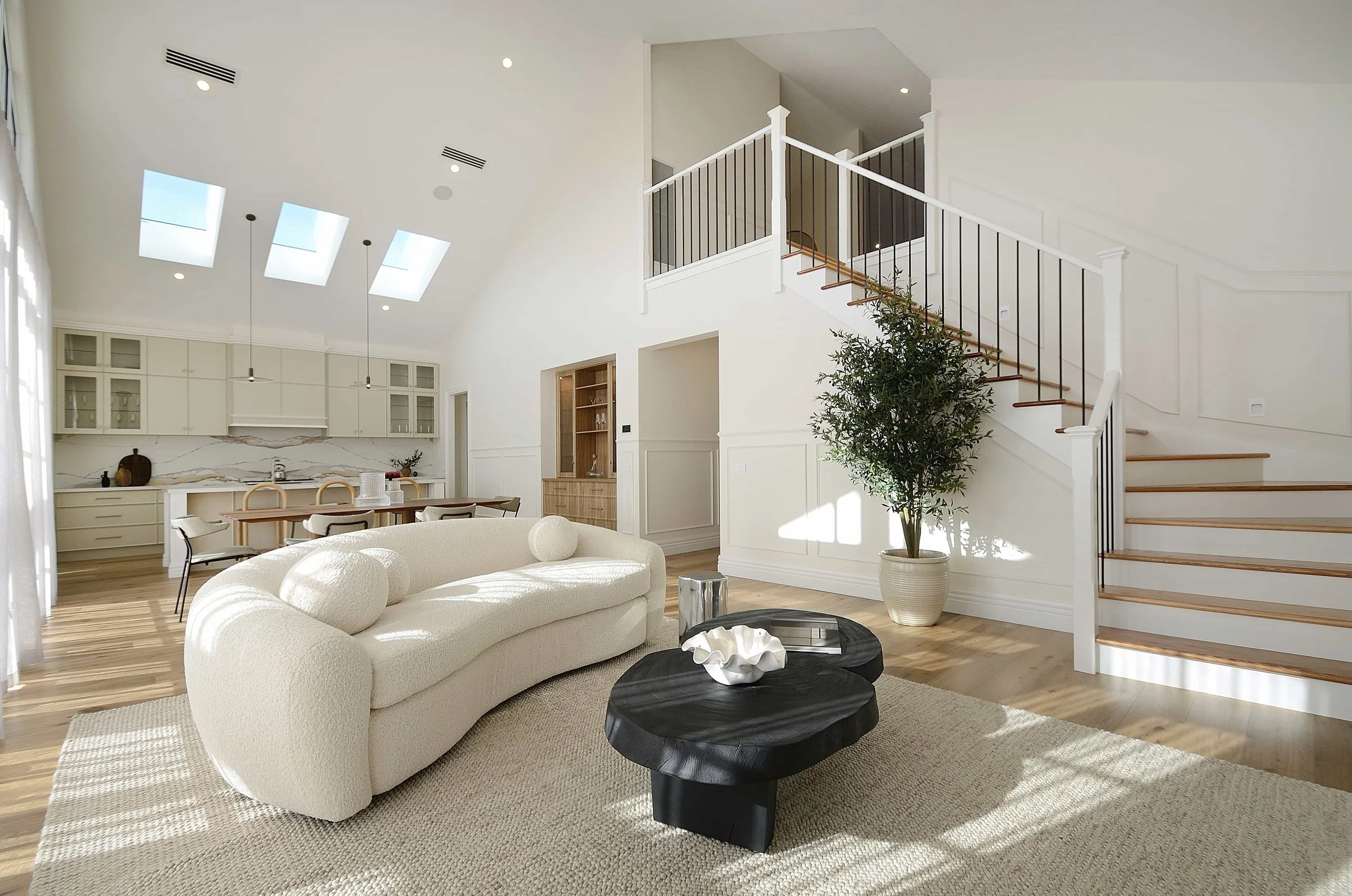 A fresh white and contemporary living room in a display home.