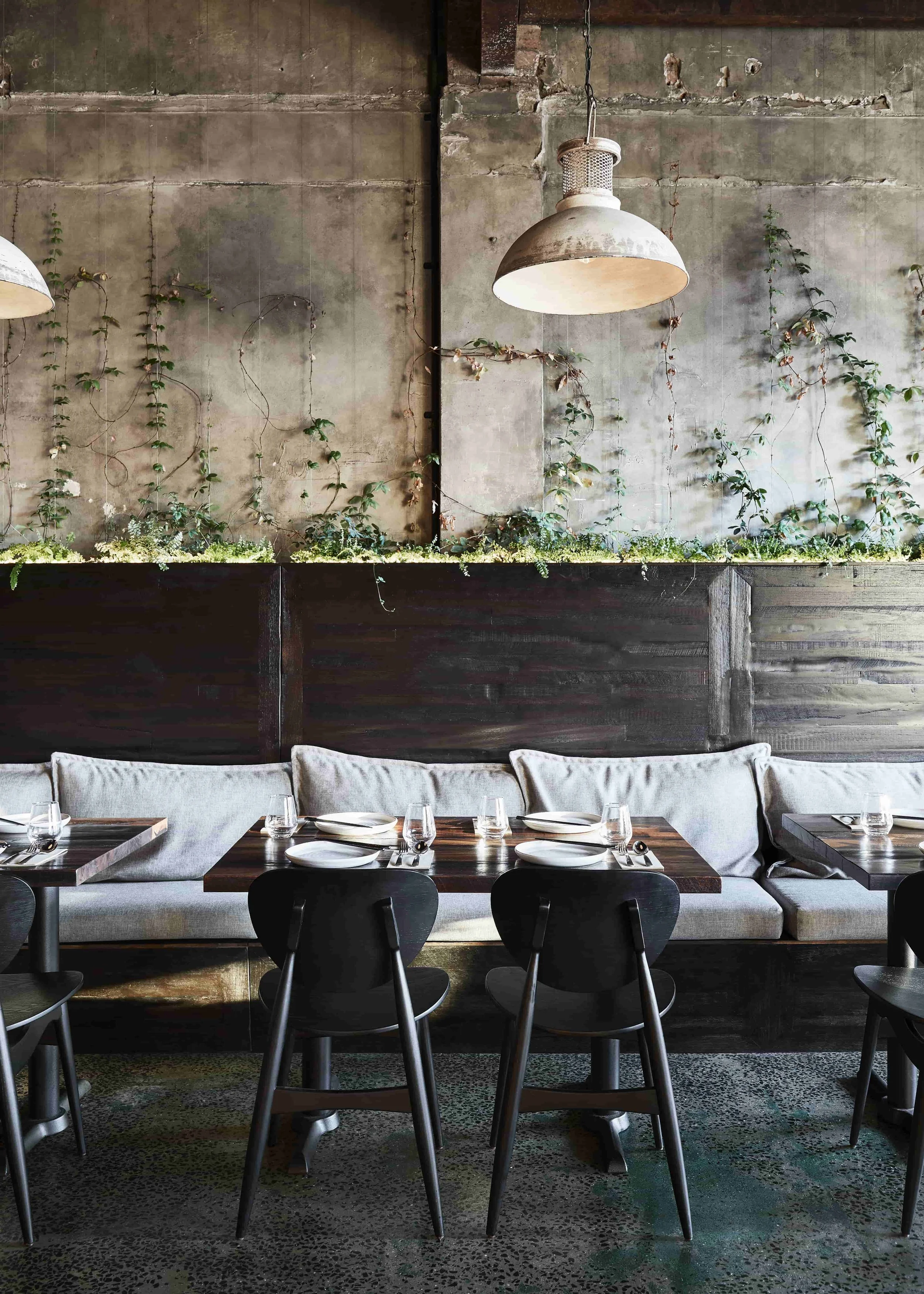 A recycled timber and charred wood seating area in a restaurant.