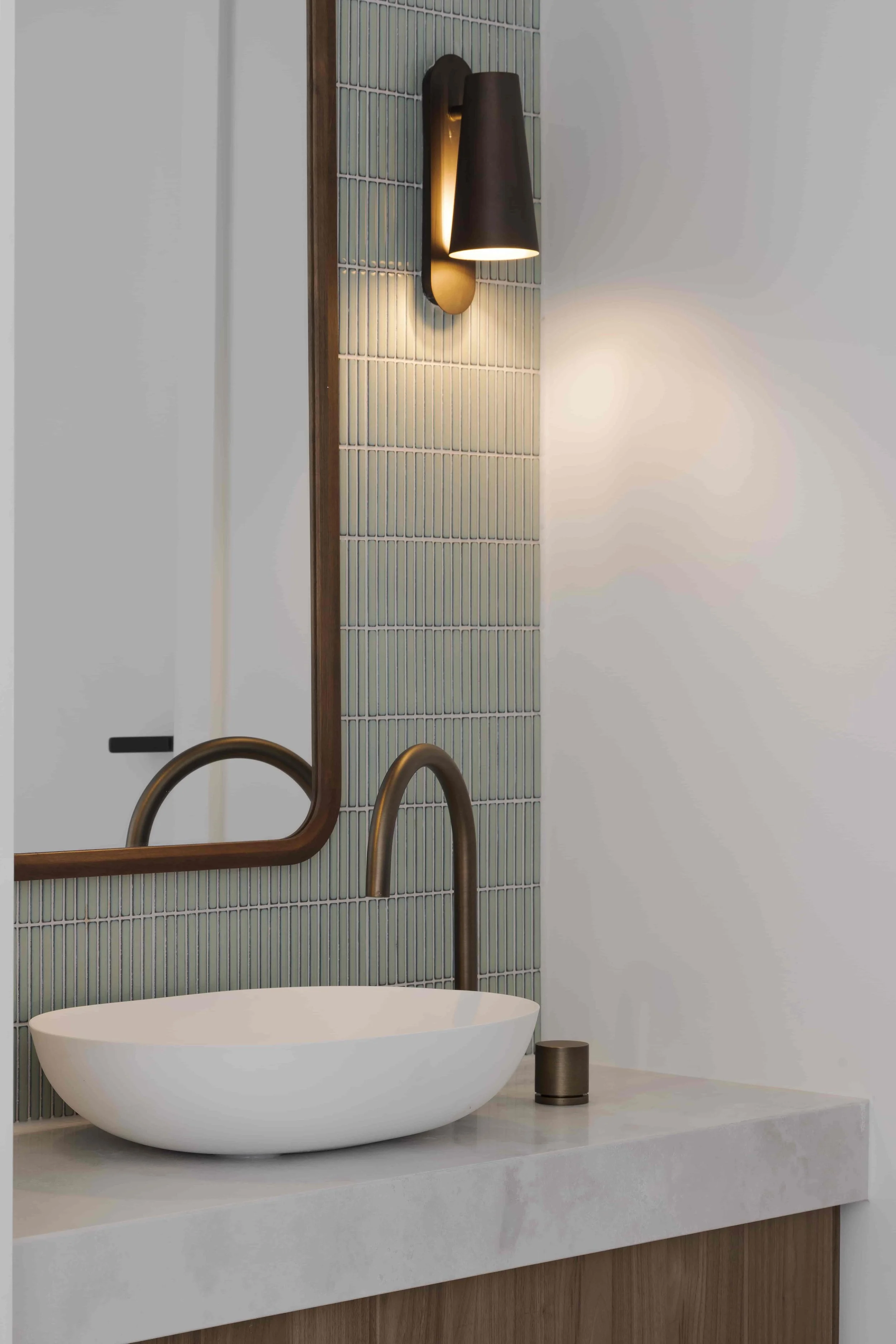 A Japanese influenced bathroom vanity with an above counter basin and contemporary colours.