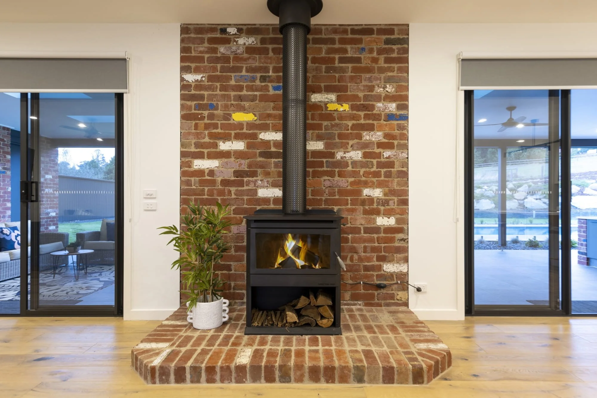 A wood fireplace on a feature brick hearth.