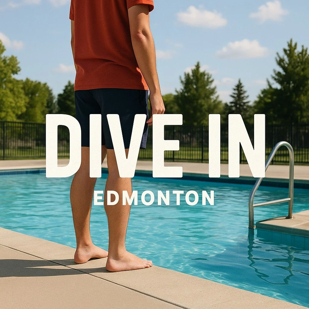 Person standing at the edge of a swimming pool with a metal handrail in Edmonton, wearing a red shirt and black shorts, with trees and a fence in the background on a sunny day.