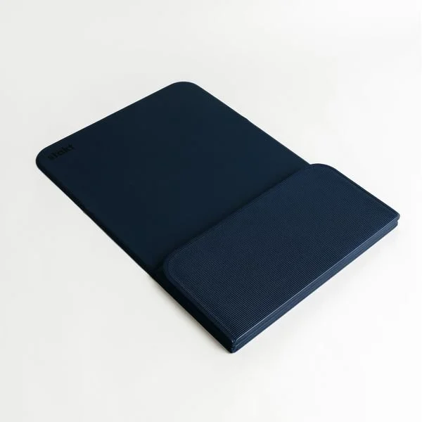 Open navy blue hardcover journal or planner with a textured cover on a white surface.