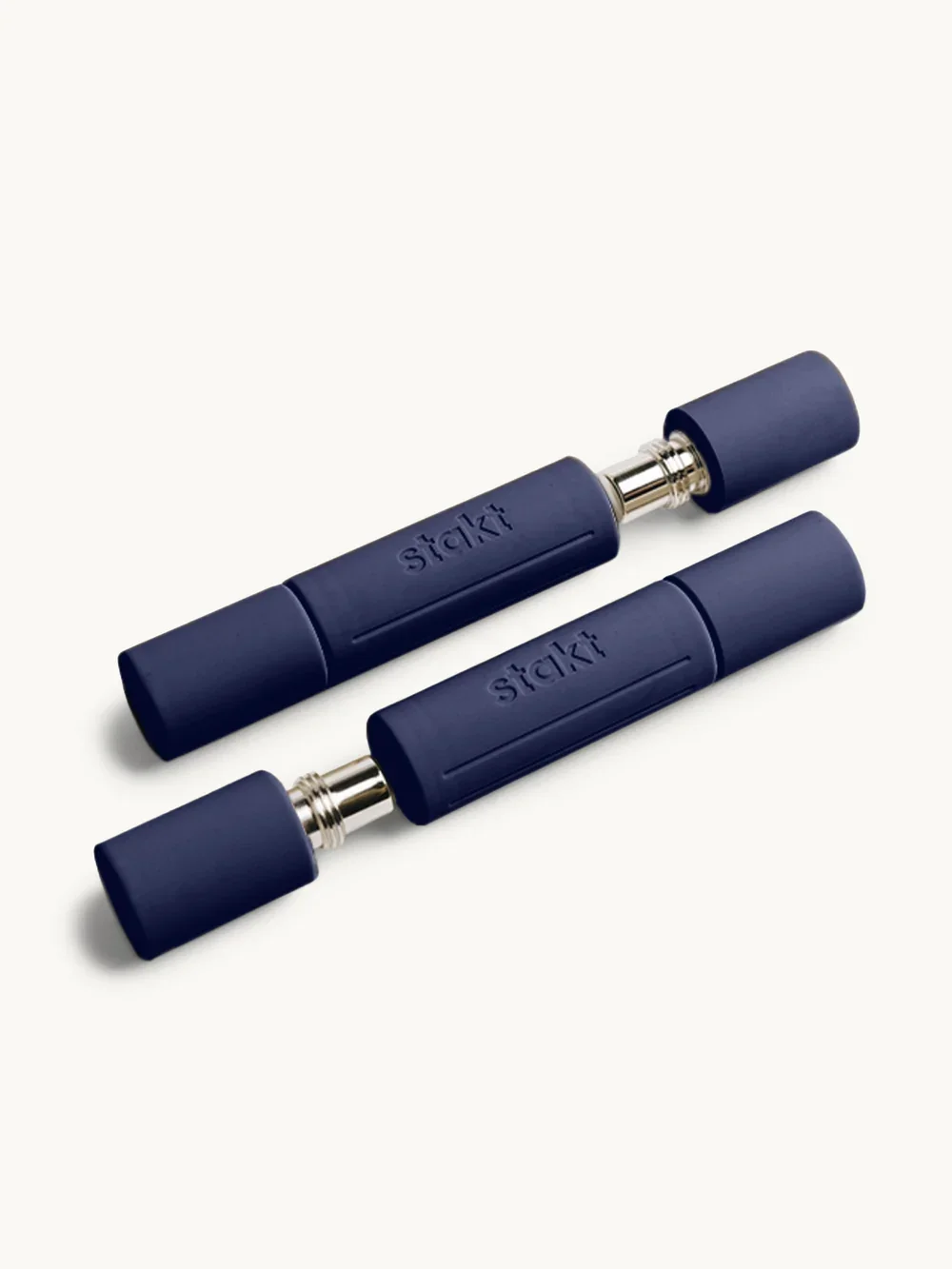 Two blue lipstick tubes lying parallel on a white surface, with one showing the lipstick mechanism.