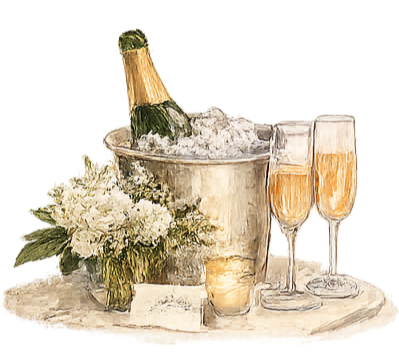 A champagne bottle in an ice bucket, two glasses of champagne, and a bouquet of white flowers on a table.