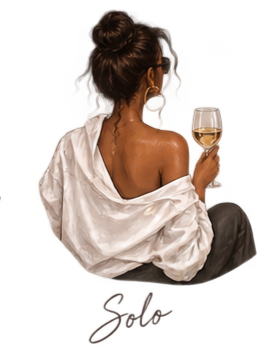 Woman with curly hair in a bun wearing a white off-shoulder top, sitting with her back to the camera, holding a glass of white wine.