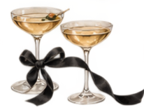 Two champagne glasses filled with champagne, decorated with black ribbons.