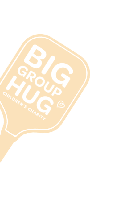 Orange hand-held sign for Big Group Hug Children's Charity with white text.