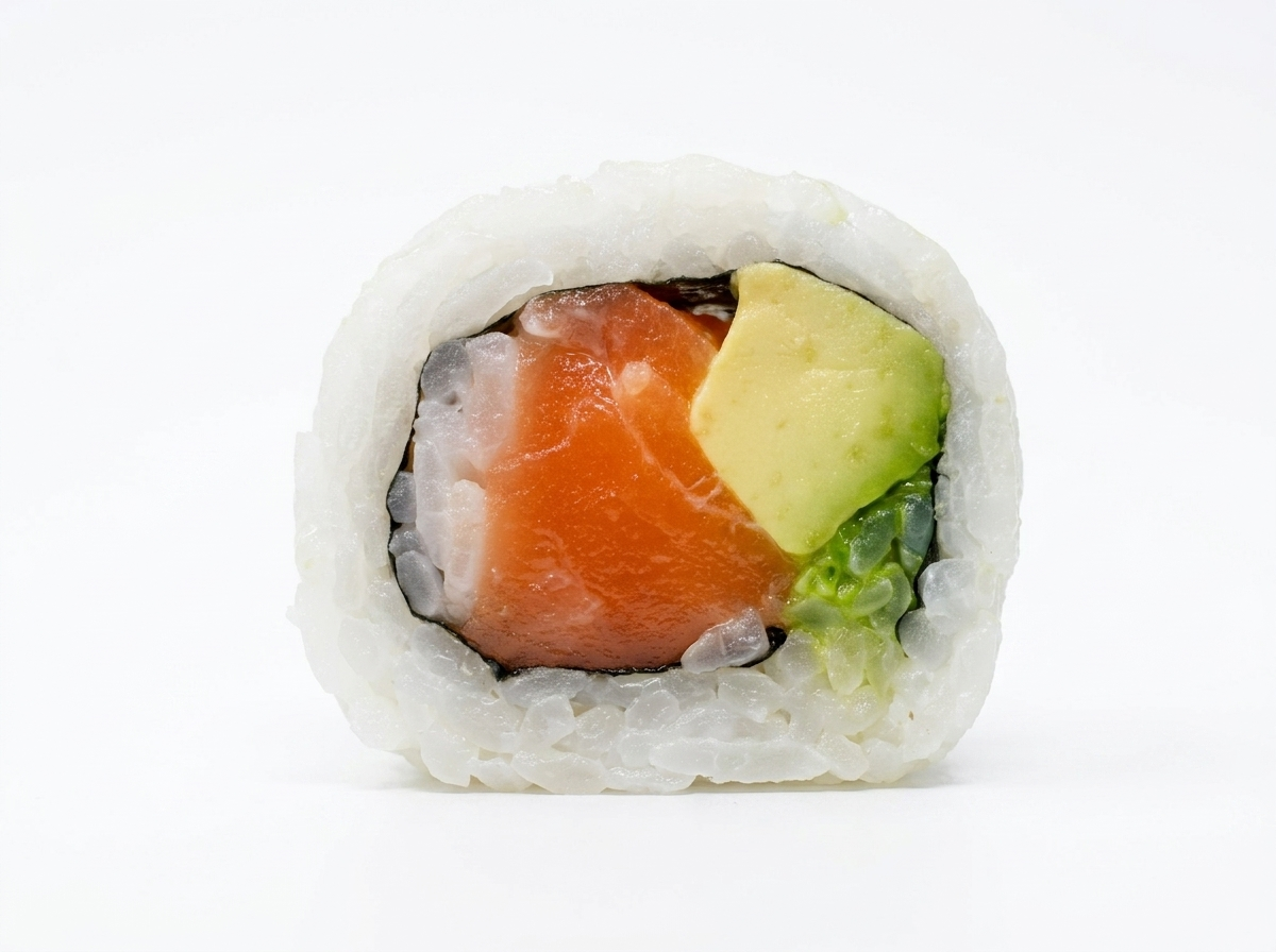 Close-up of a California sushi roll with avocado, salmon, and rice against a white background.