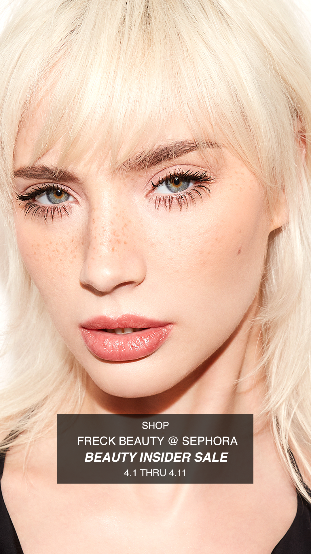 Close-up of a woman with platinum blonde hair, light skin, freckles, and makeup, advertising a beauty sale at Sephora.