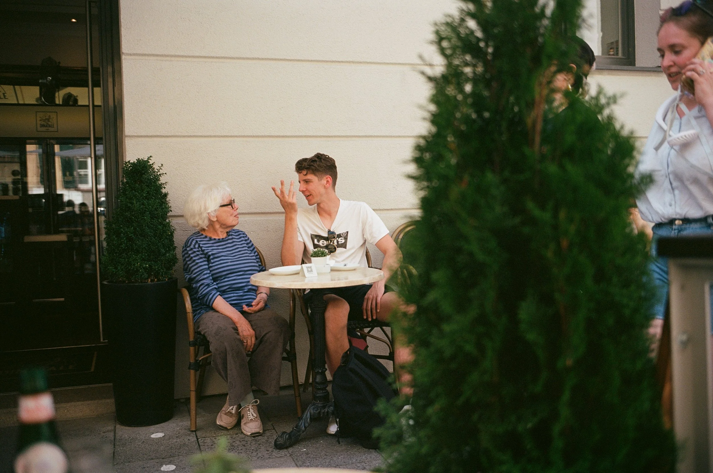 old person and young man talking