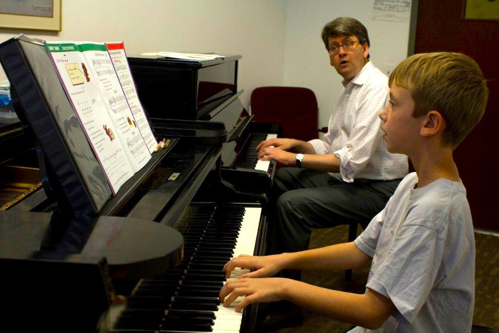 Ted Cooper teaching a young piano student
