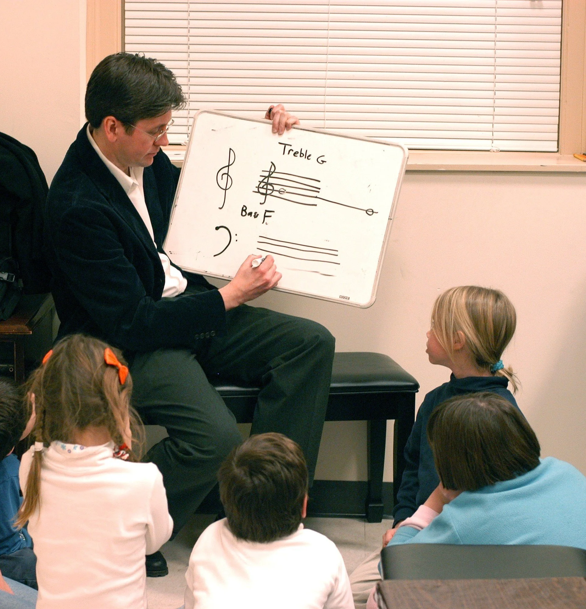 Ted Cooper teaching children about treble and bass clefs.