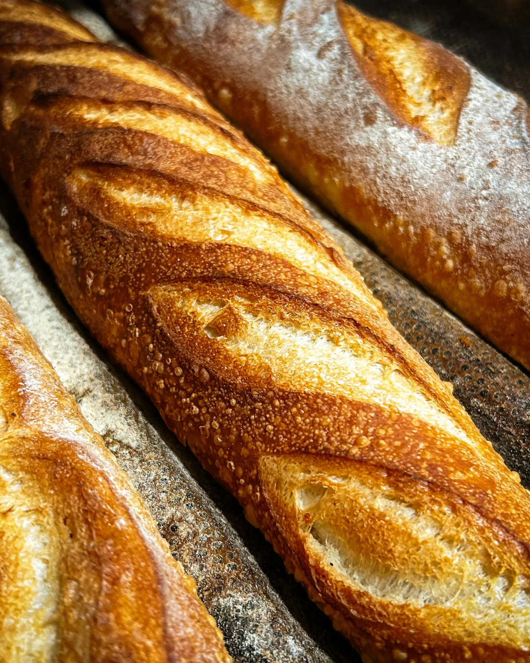 Close-up of freshly baked French baguettes with a golden brown crust.