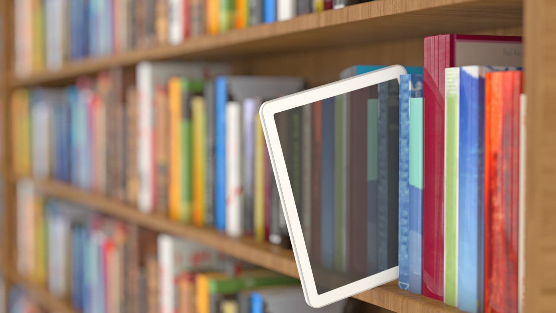 E-reader placed among colorful books on a wooden bookshelf, with more books softly blurred in the background.