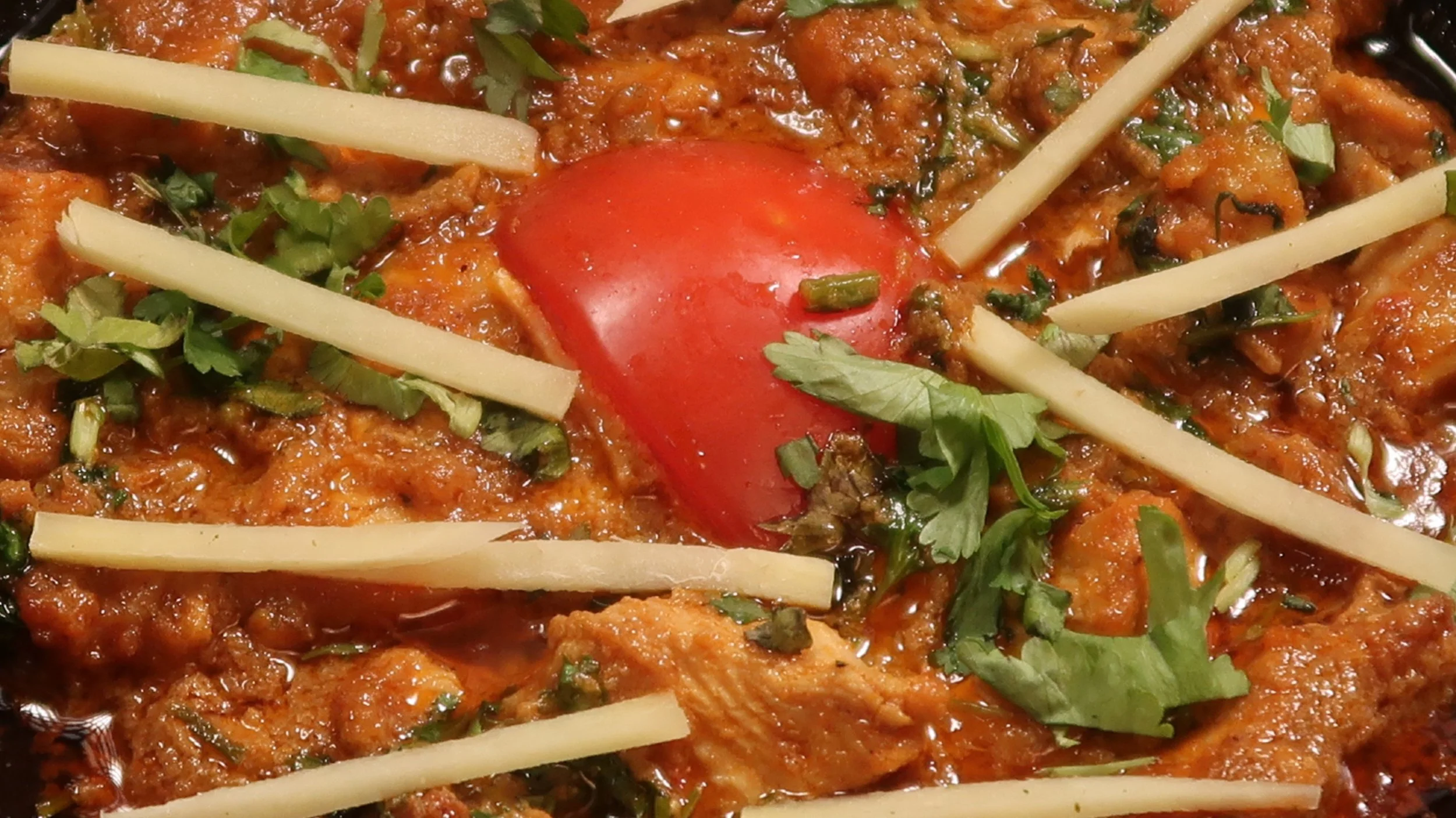 Karahi Chicken | Our boneless diced chicken cooked with fresh garlic, ginger, onions, tomatoes and spices. 