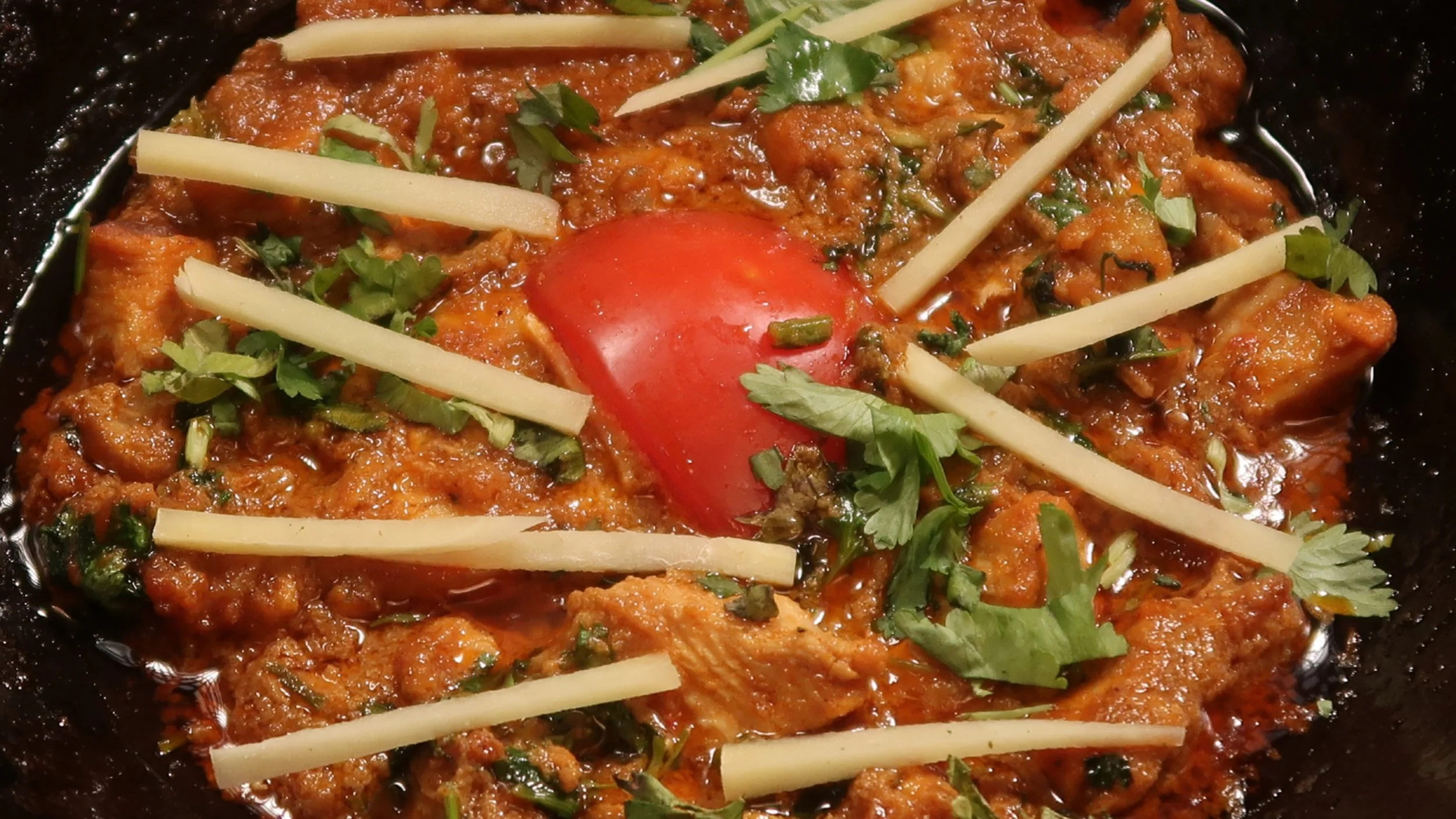 Karahi Chicken | Our boneless diced chicken cooked with fresh garlic, ginger, onions, tomatoes and spices. 